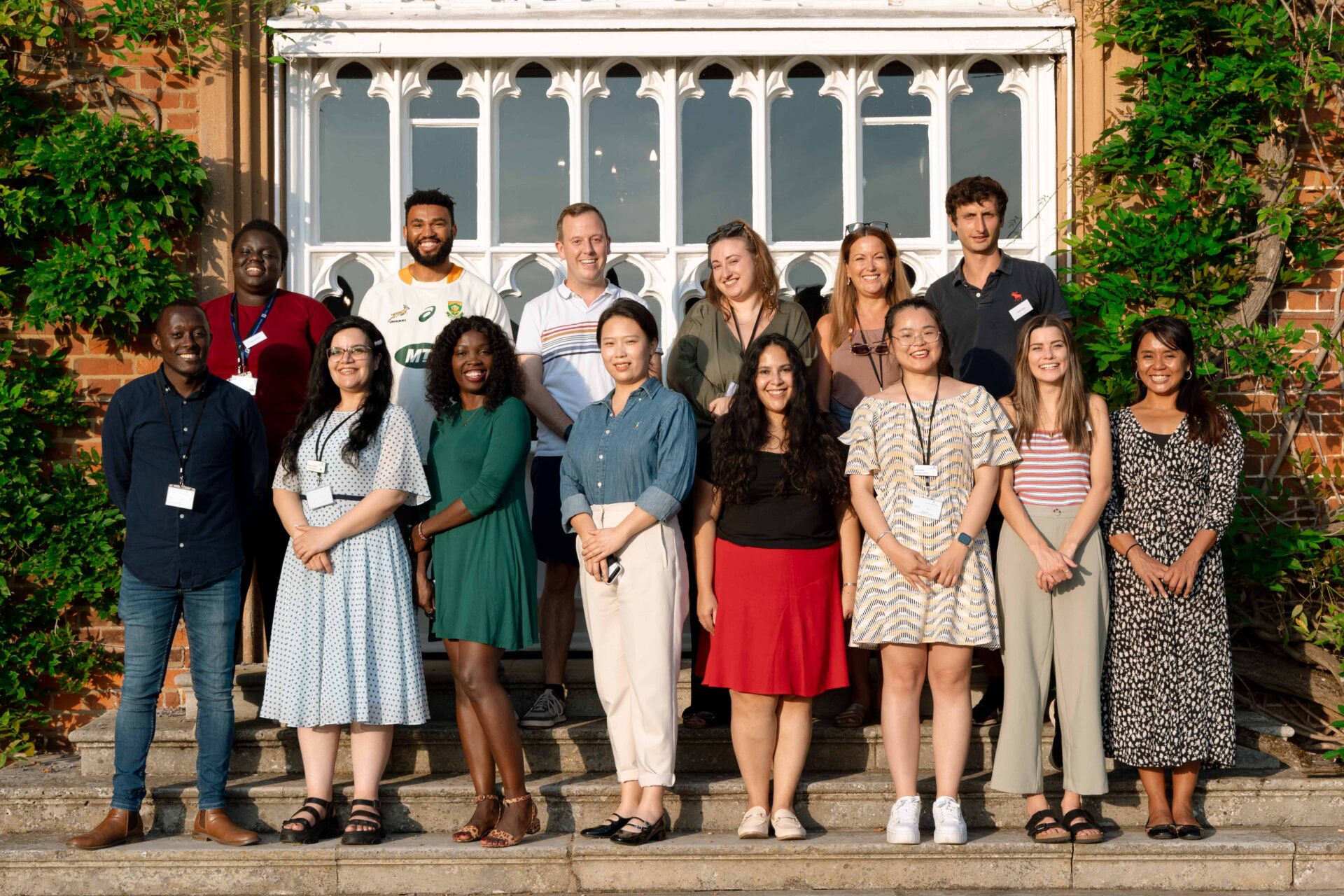 First and second-year Cumberland Lodge Fellows photographed together on the steps outside the Tapestry Hall.