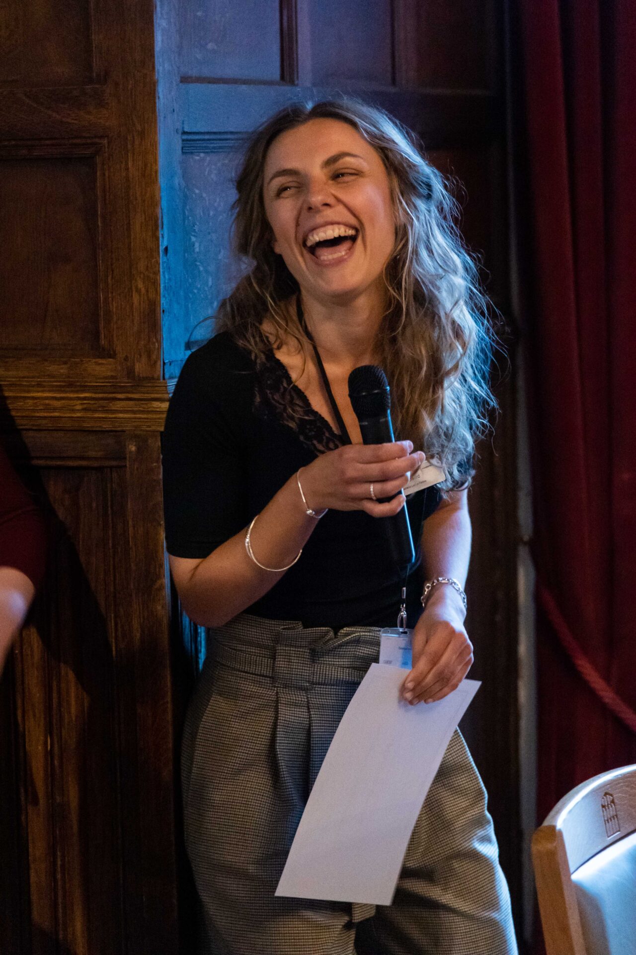 A Cumberland Lodge Fellow laughing as she gives a speech.