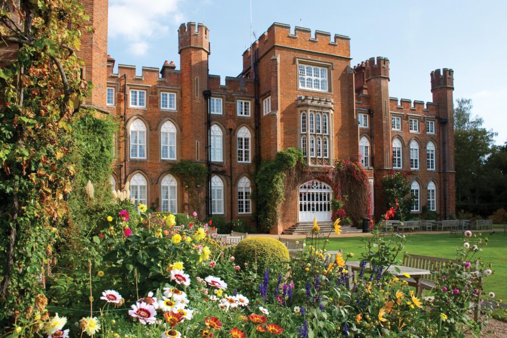 A view of Cumberland Lodge through a colourful flowerbed