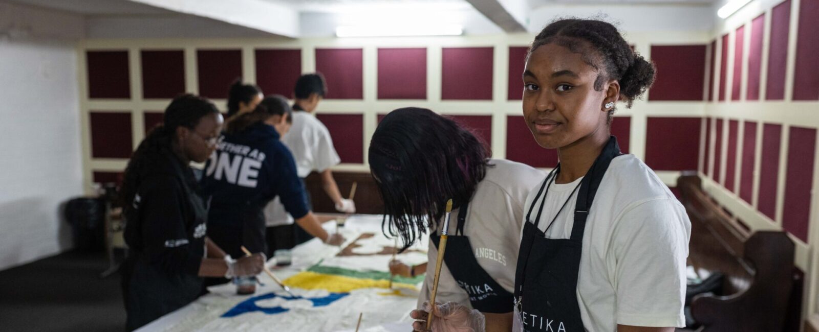 Youth Arts Takeover participant working on the tapestry painting