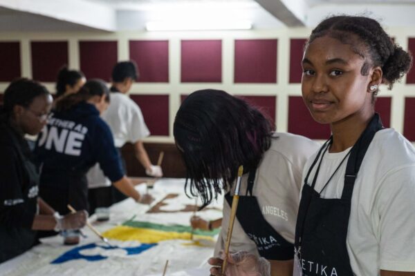 Youth Arts Takeover participant working on the tapestry painting