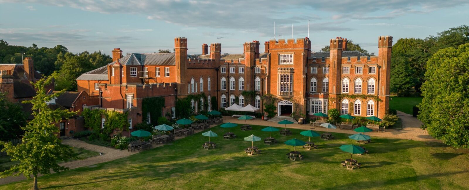 An aerial photo of the red brick Cumberland Lodge building and gardens